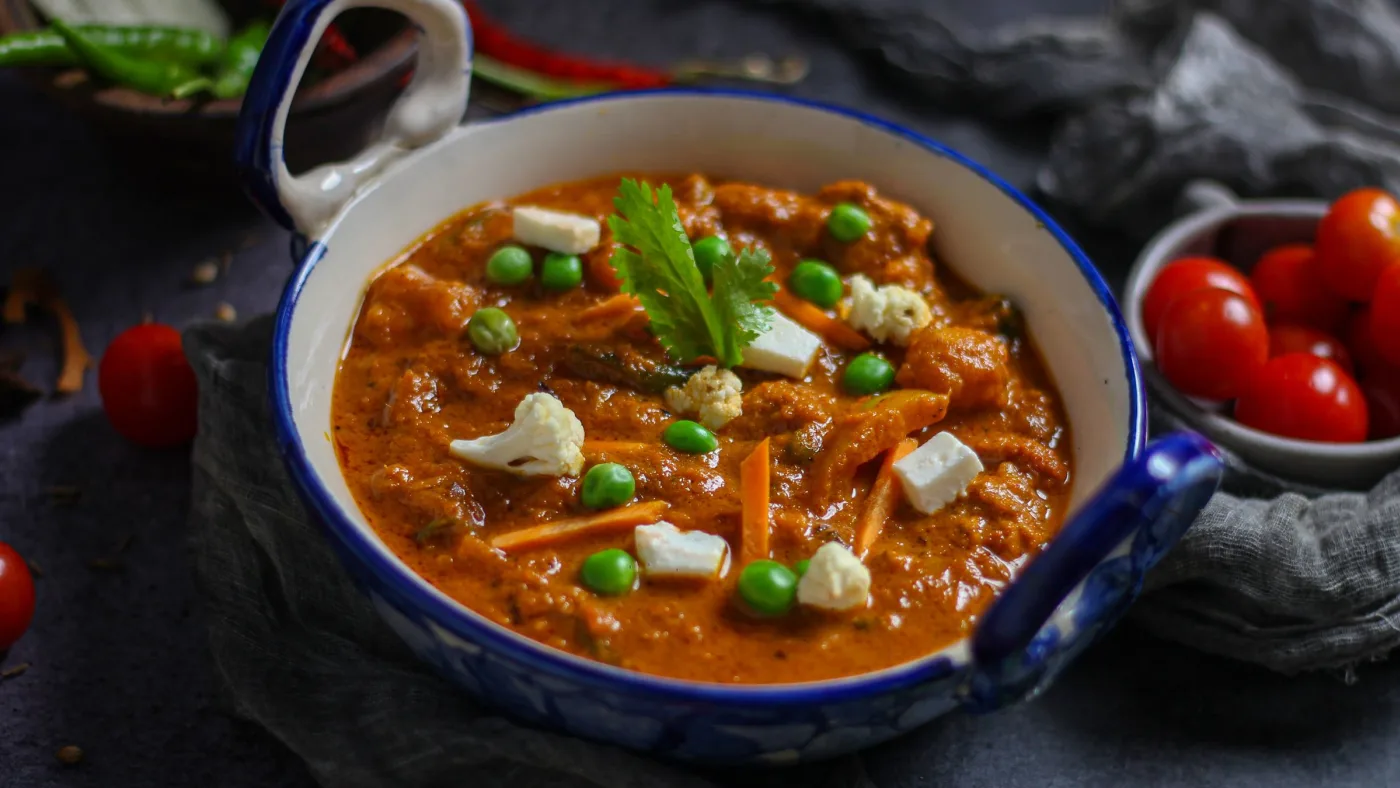 Paneer and peas in a homestyle gravy, served in a blue bowl