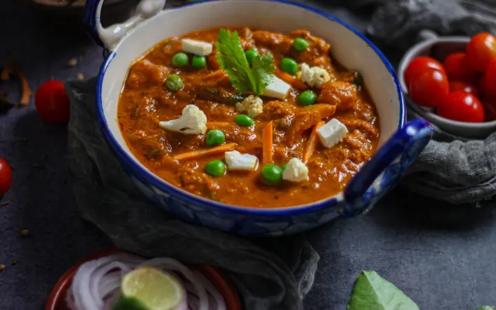 Paneer and peas in a homestyle gravy, served in a blue bowl